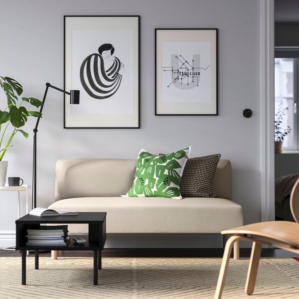 Beige LILLEHEM two-seat sofa in the living room with two cushions on top. 
