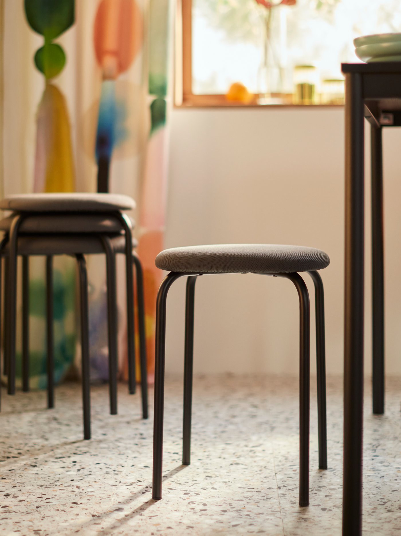 The upholstered GULTARP stool with soft padding.