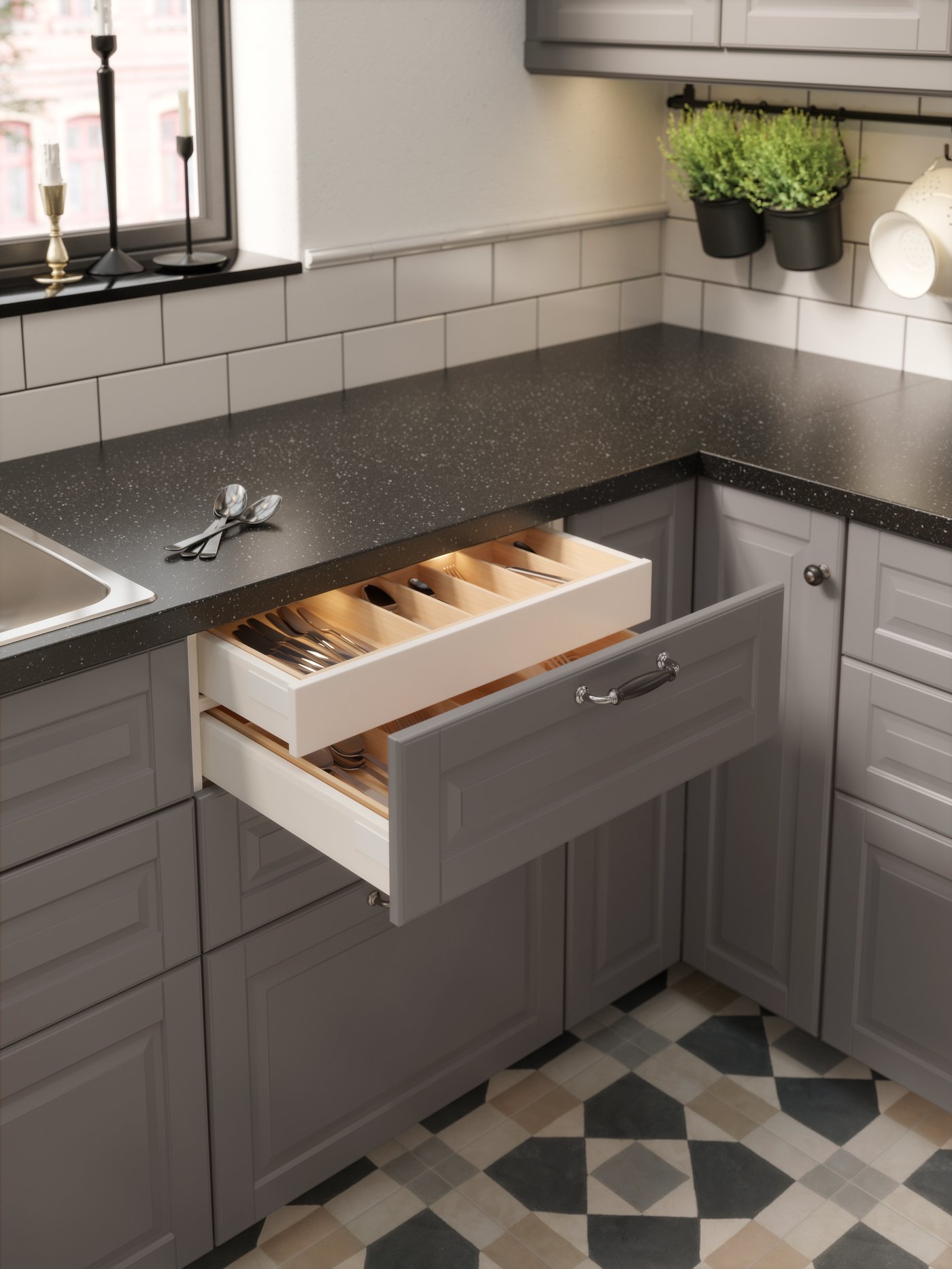 A black/chrome-plated SKÄRHAMN handle in the kitchen