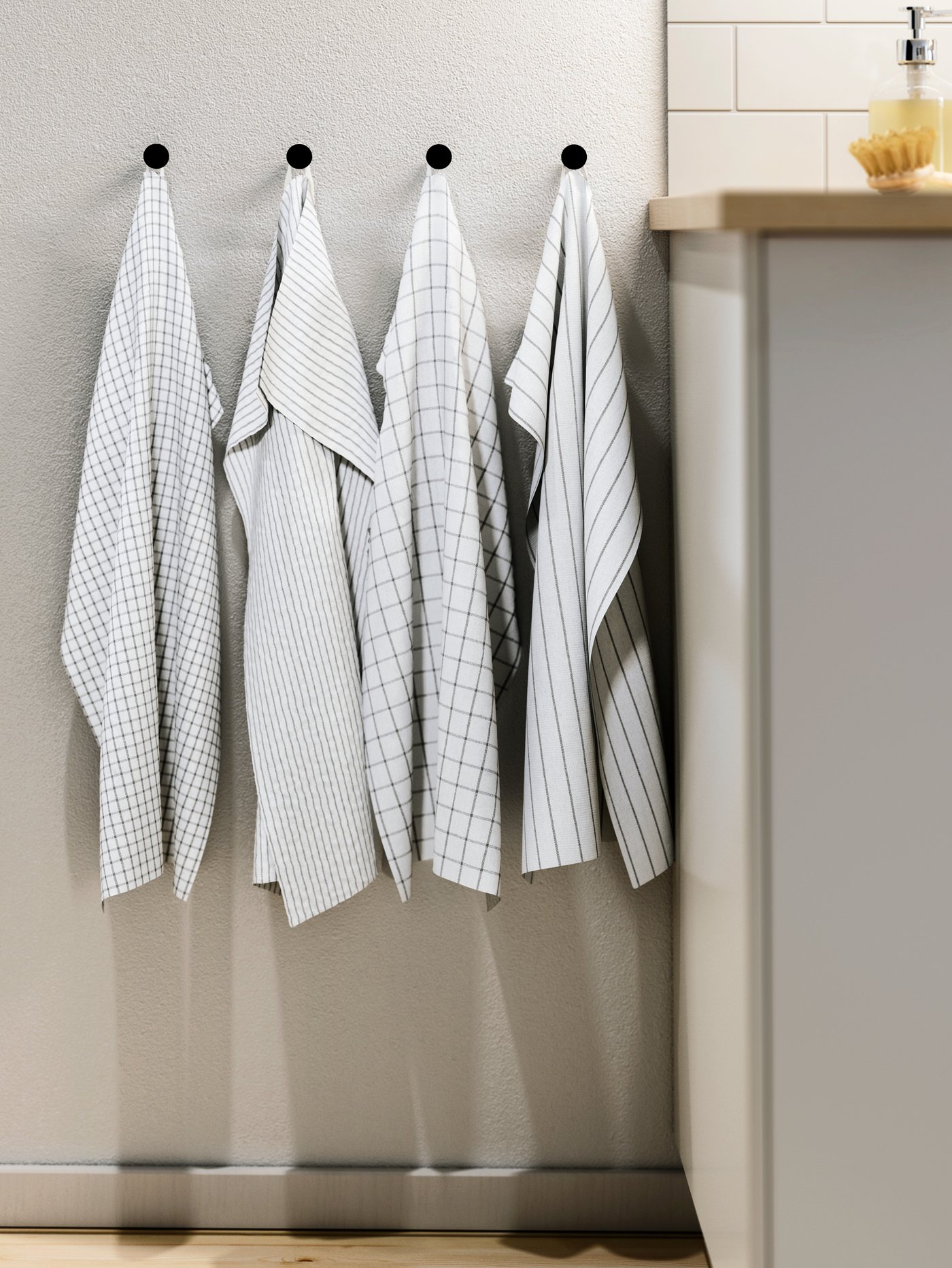 A white/dark grey/patterned RINNIG tea towel in the kitchen