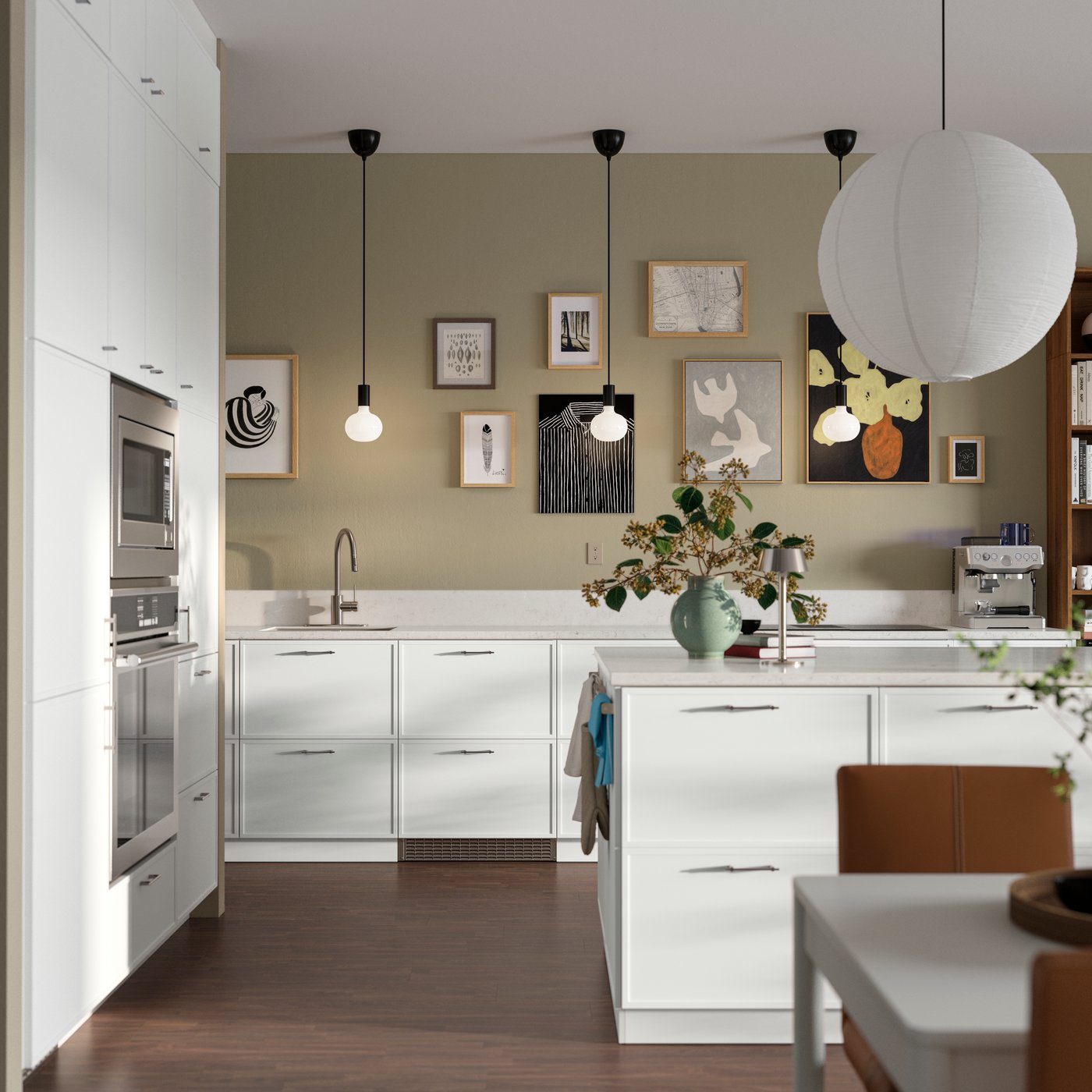 A kitchen with white SEKTION cabinets paired with ASPUDDEN matt white fronts featuring a kitchen island and modern decor.