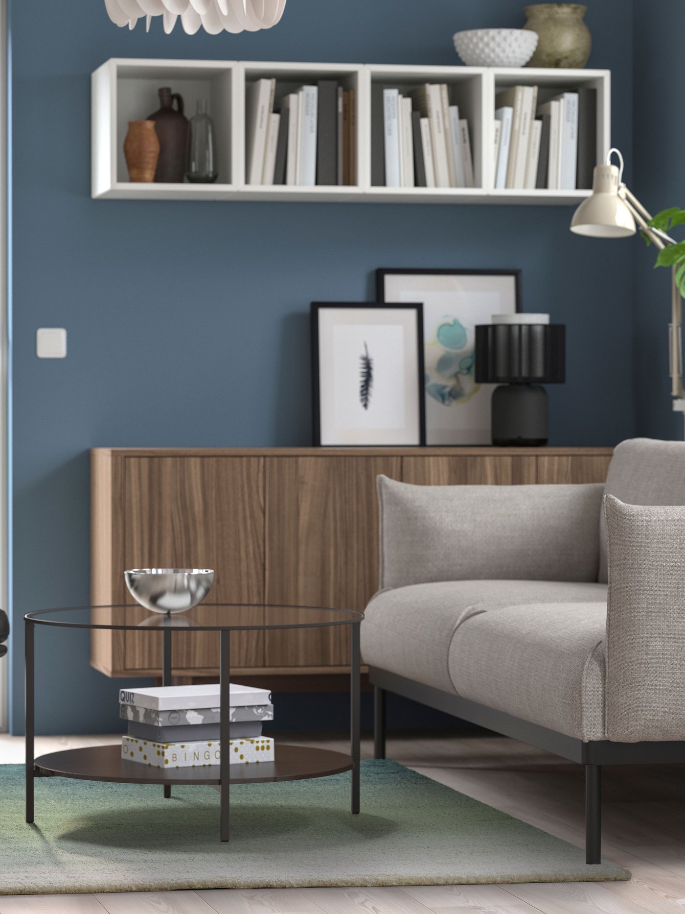 A white EKET wall-mounted shelving unit in the living room