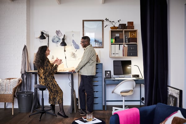 A black SKURUP wall lamp in the home office