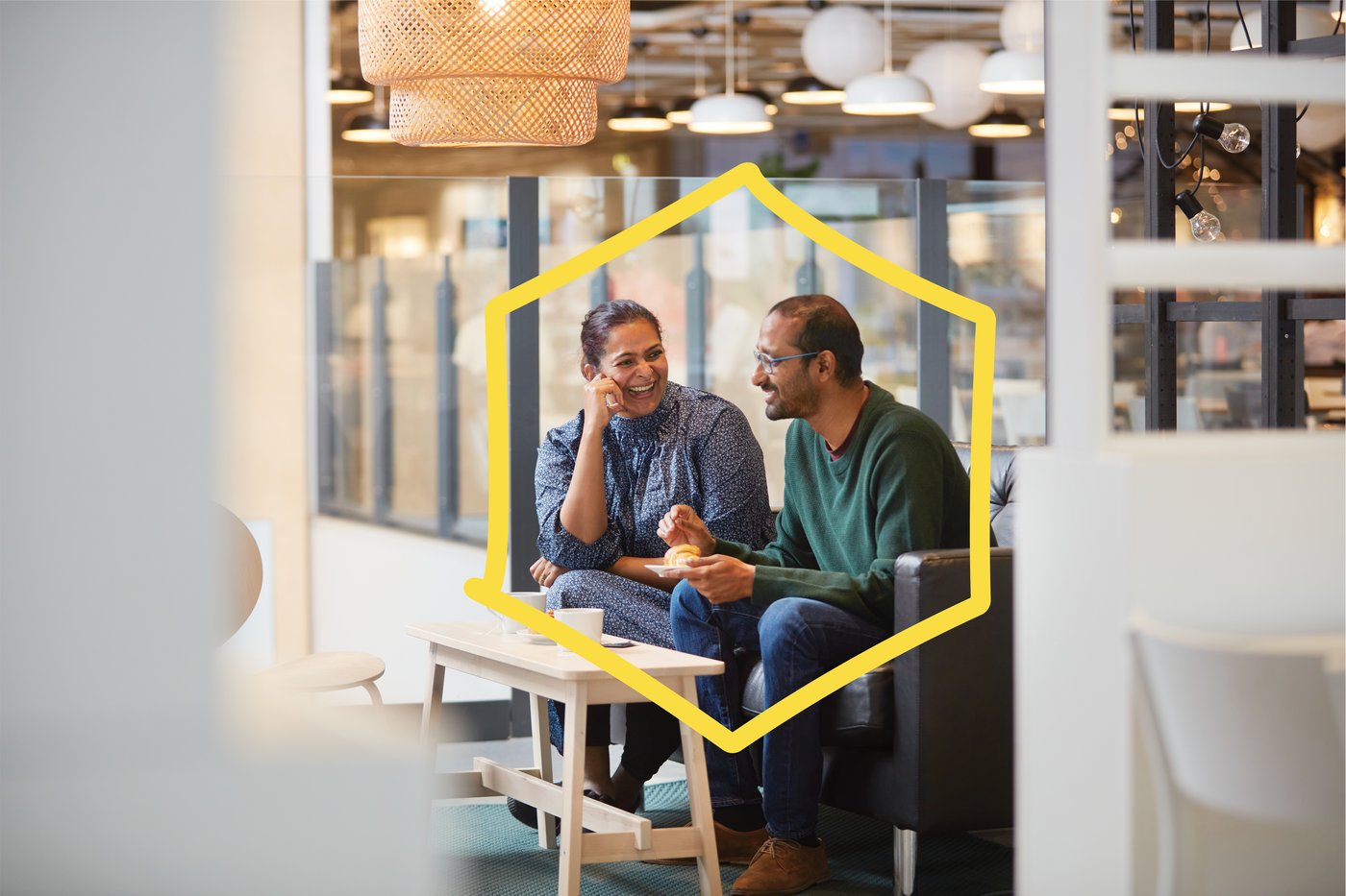 A couple sharing a laugh over a meal.