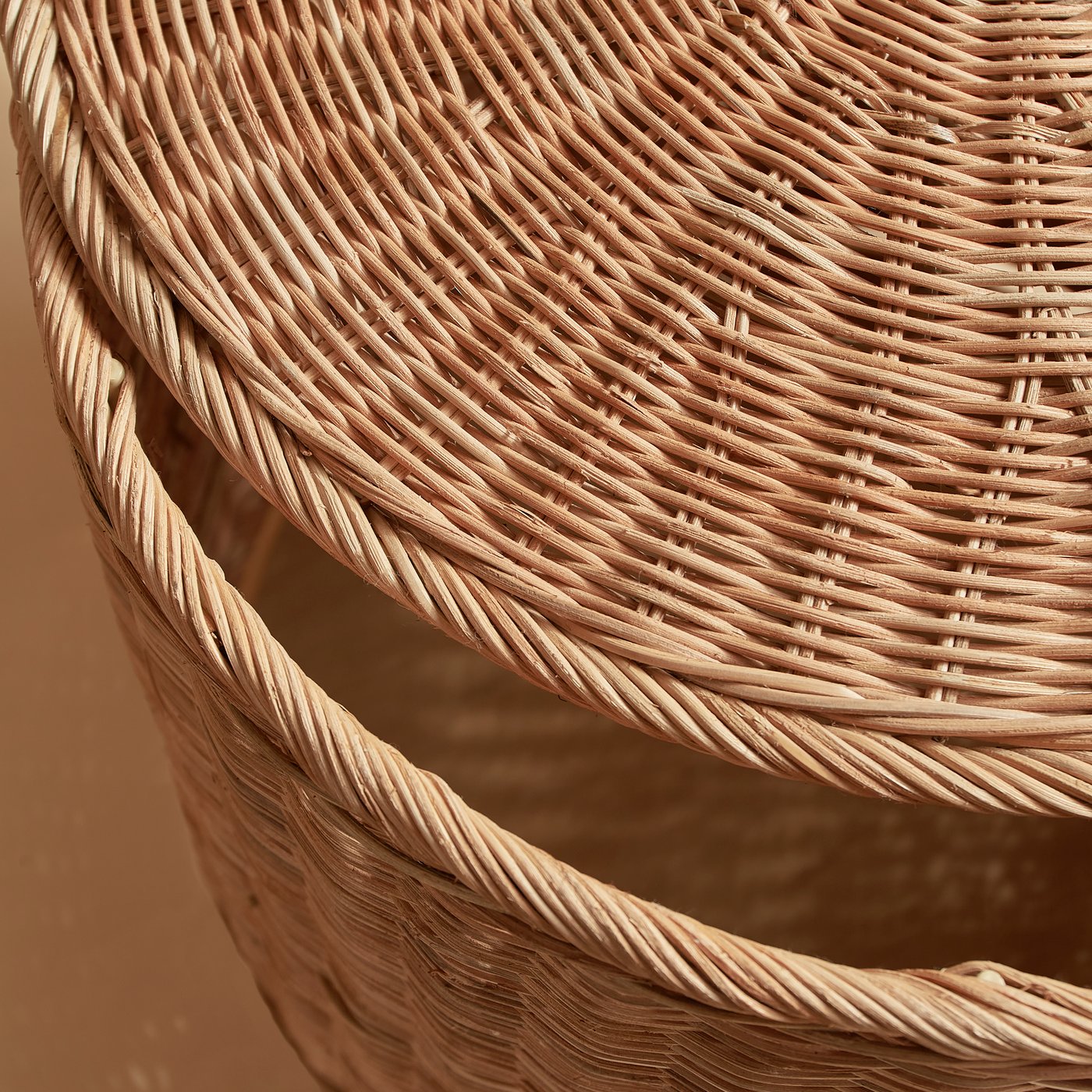 A handmade rattan TOLKNING pouffe with storage