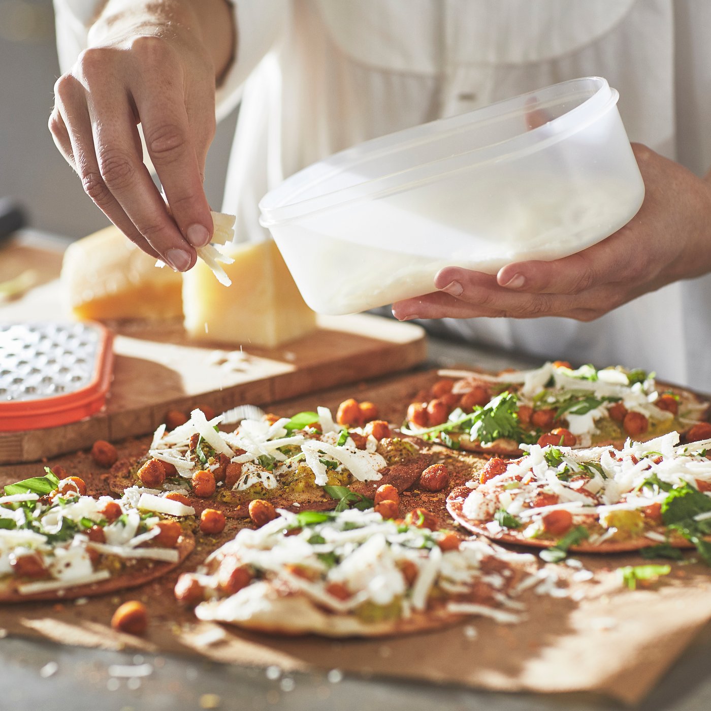 A mixed colours UPPFYLLD grater with container