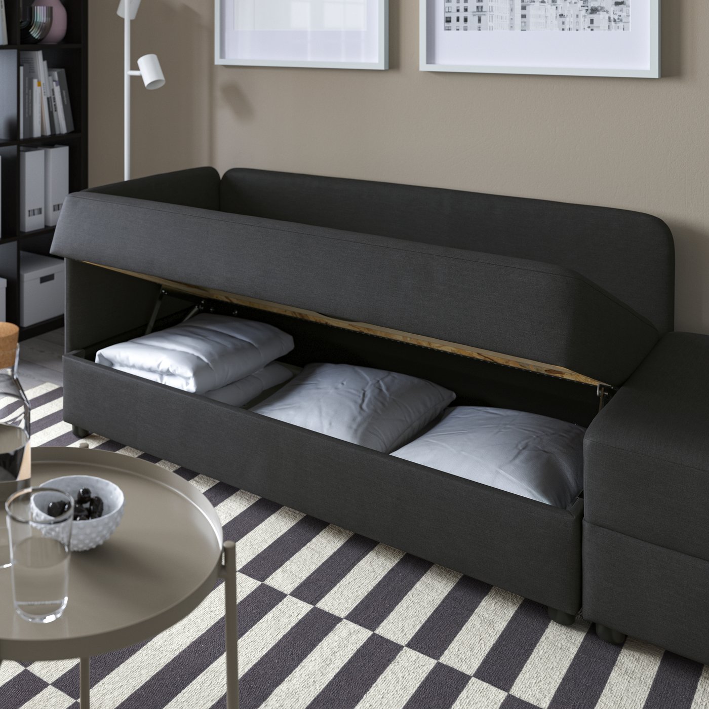 A Vissle dark grey LINDÅKRA 2-seat sofa-bed in the living room