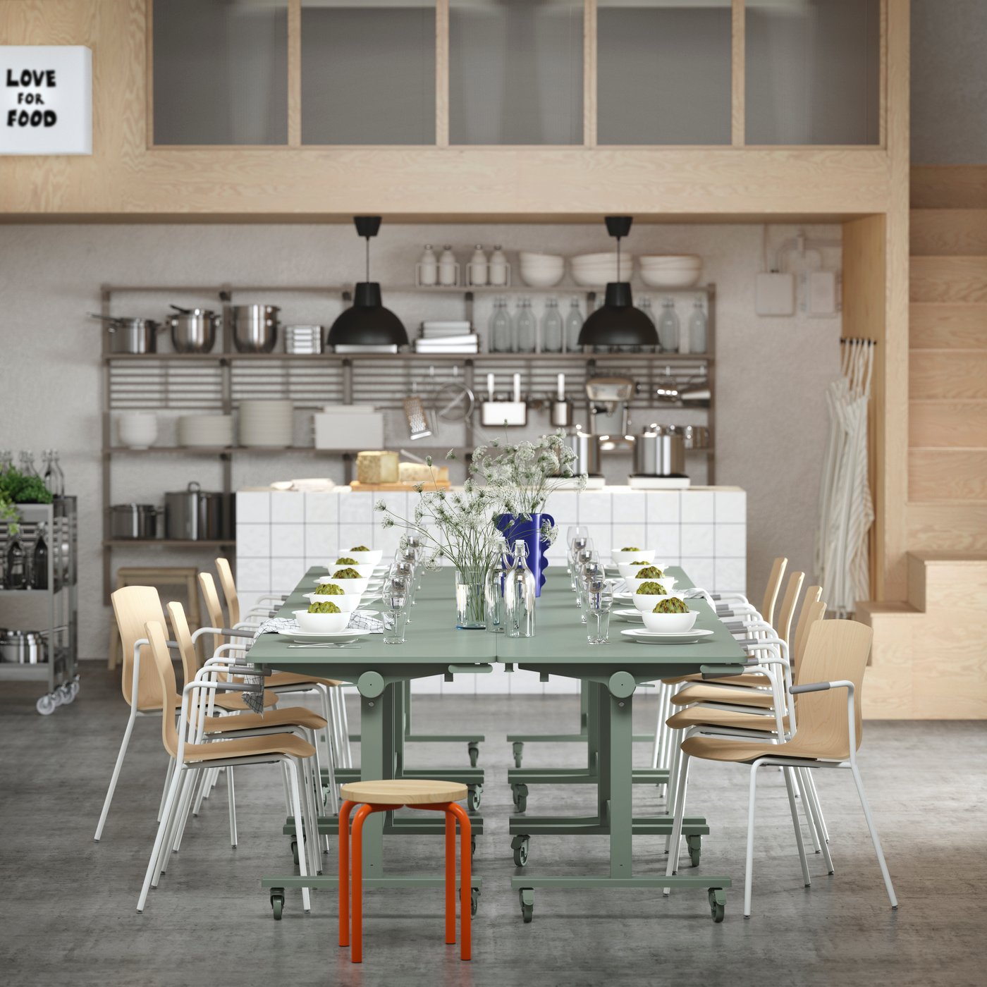 Several green MITTZON tables arranged for dining, paired with LÄKTARE conference chairs and an orange/pine DOMSTEN stool.