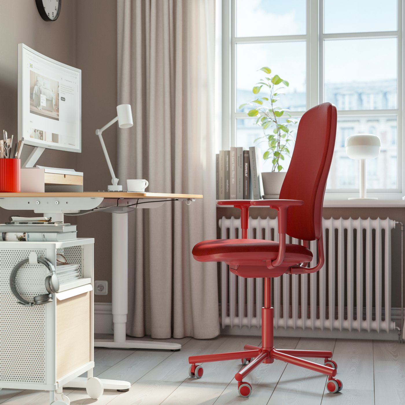 A Gräsnäs red SMÖRKULL office chair with armrests