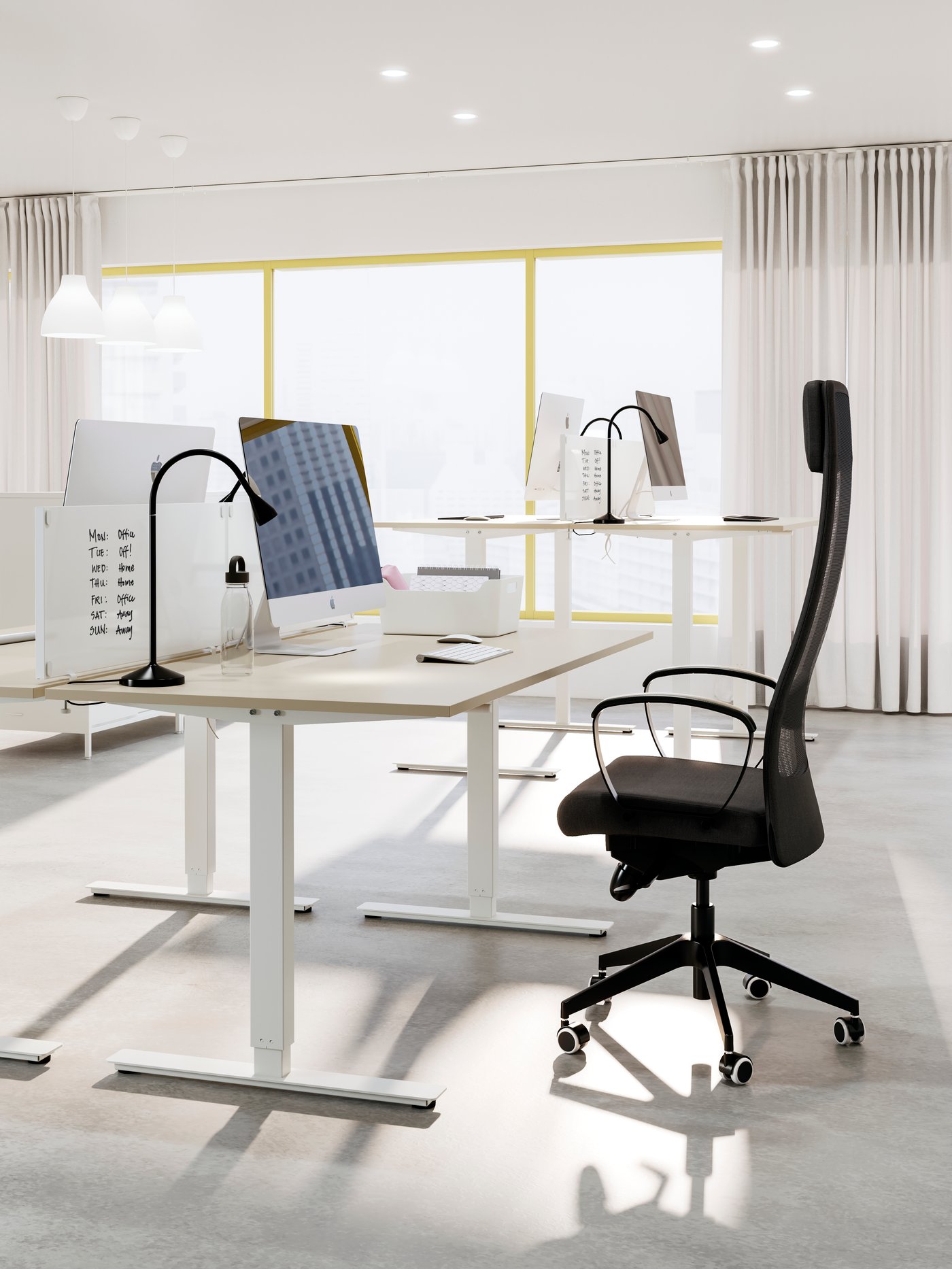 A TROTTEN desk with a black desk chair in the office.