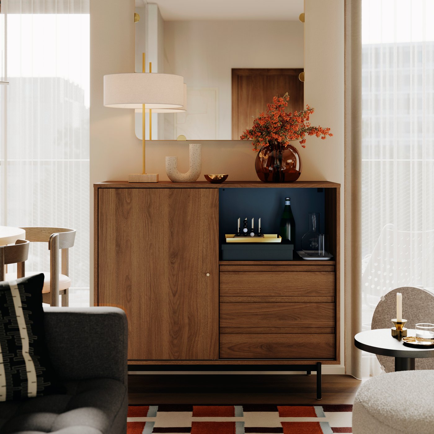 A STOCKHOLM 2025 table lamp and a vase with flowers stand on top of a RÅDMANSJÖ cabinet in an Instagram worthy living room.