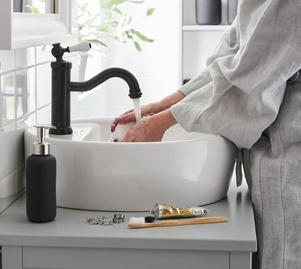 A black HAMNSKÄR wash-basin mixer tap with strainer