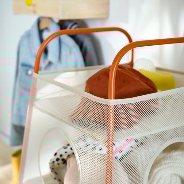 Close-up of TIGERFINK storage with compartments in beige with orange details, full of caps and accessories.