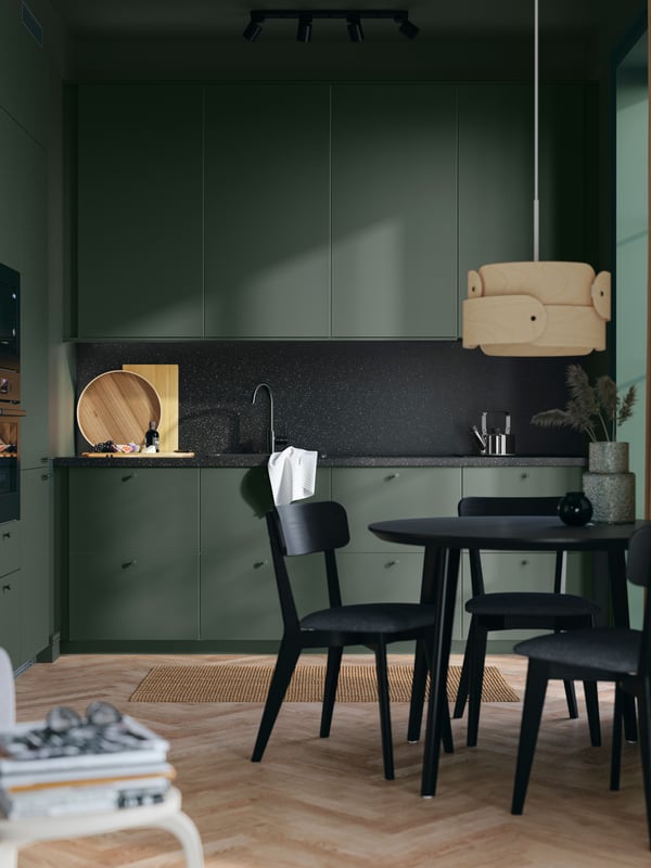A deep green HAVSTORP door in the dining room