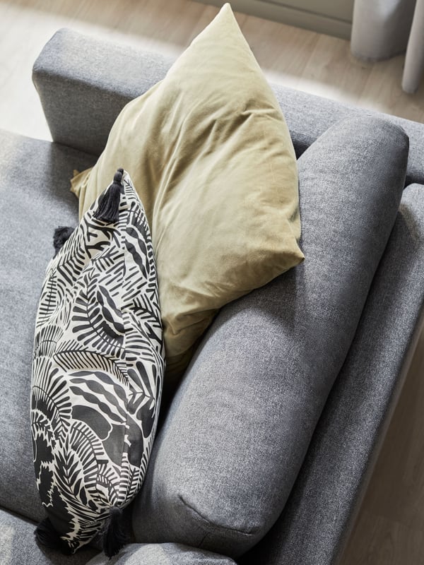 A light olive-green SANELA cushion cover