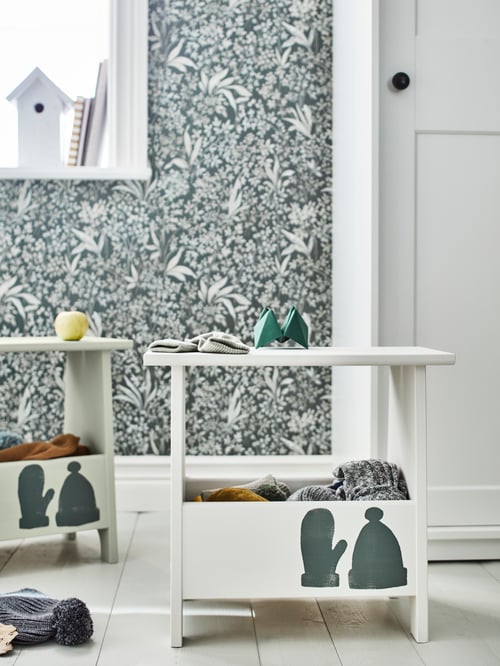 A hallway with multiple beige stools with storage made of solid pine and a white wardrobe with sliding doors.