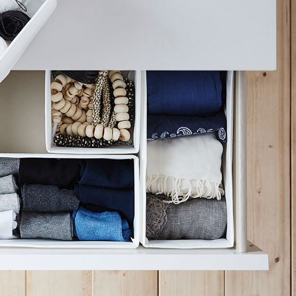 Close-up taken from above a drawer with different sized SKUBB boxes full of socks and accessories in neat order.