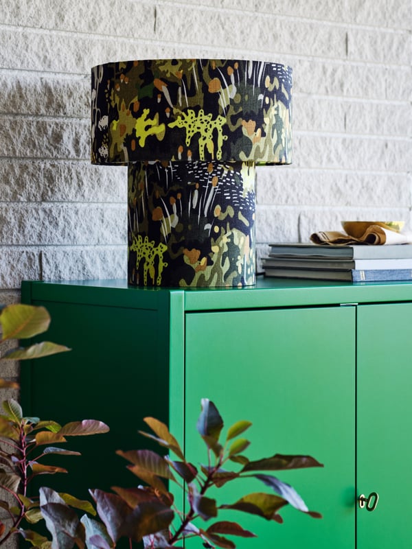 A green STOCKHOLM 2025 cabinet with 2 doors
