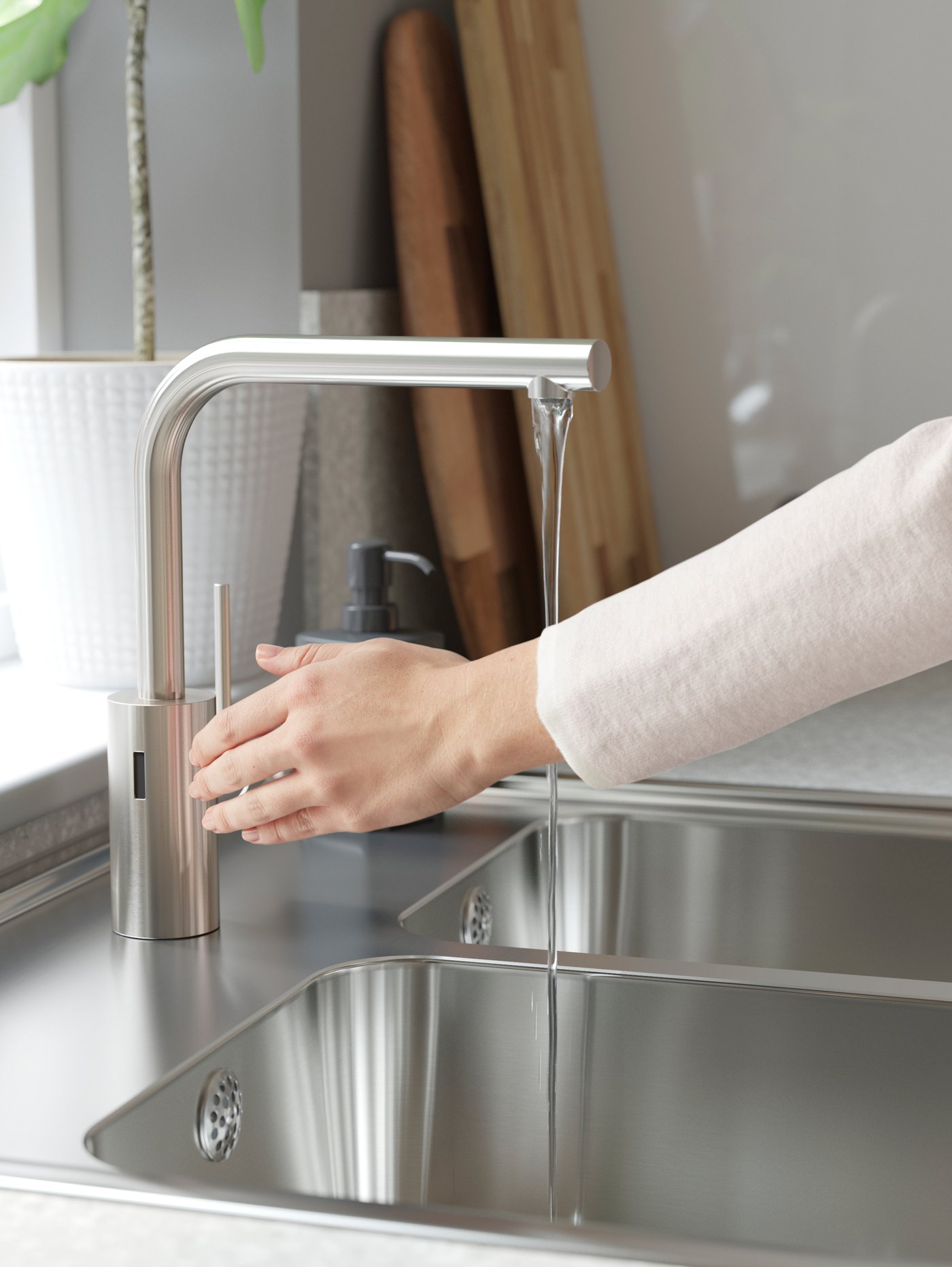 Stainless steel kitchen mixer tap and a double bowl stainless steel sink