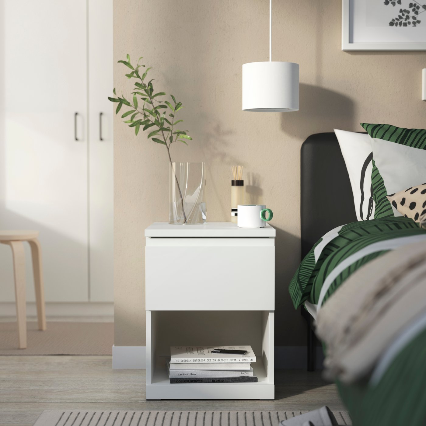 A white/with 1 drawer STORKLINTA bedside table in the bedroom