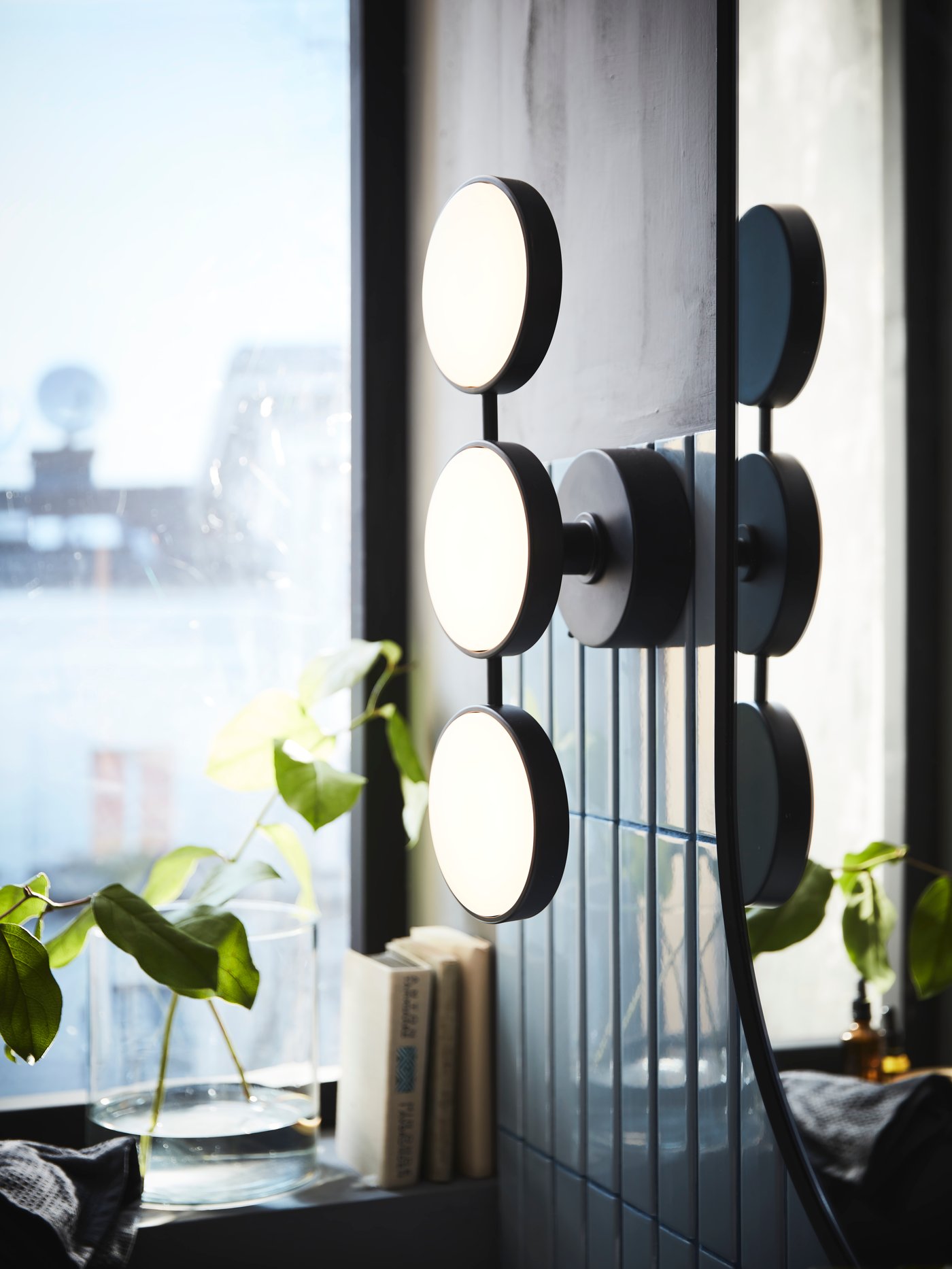 A dimmable matt/black KABOMBA LED wall lamp in the bathroom