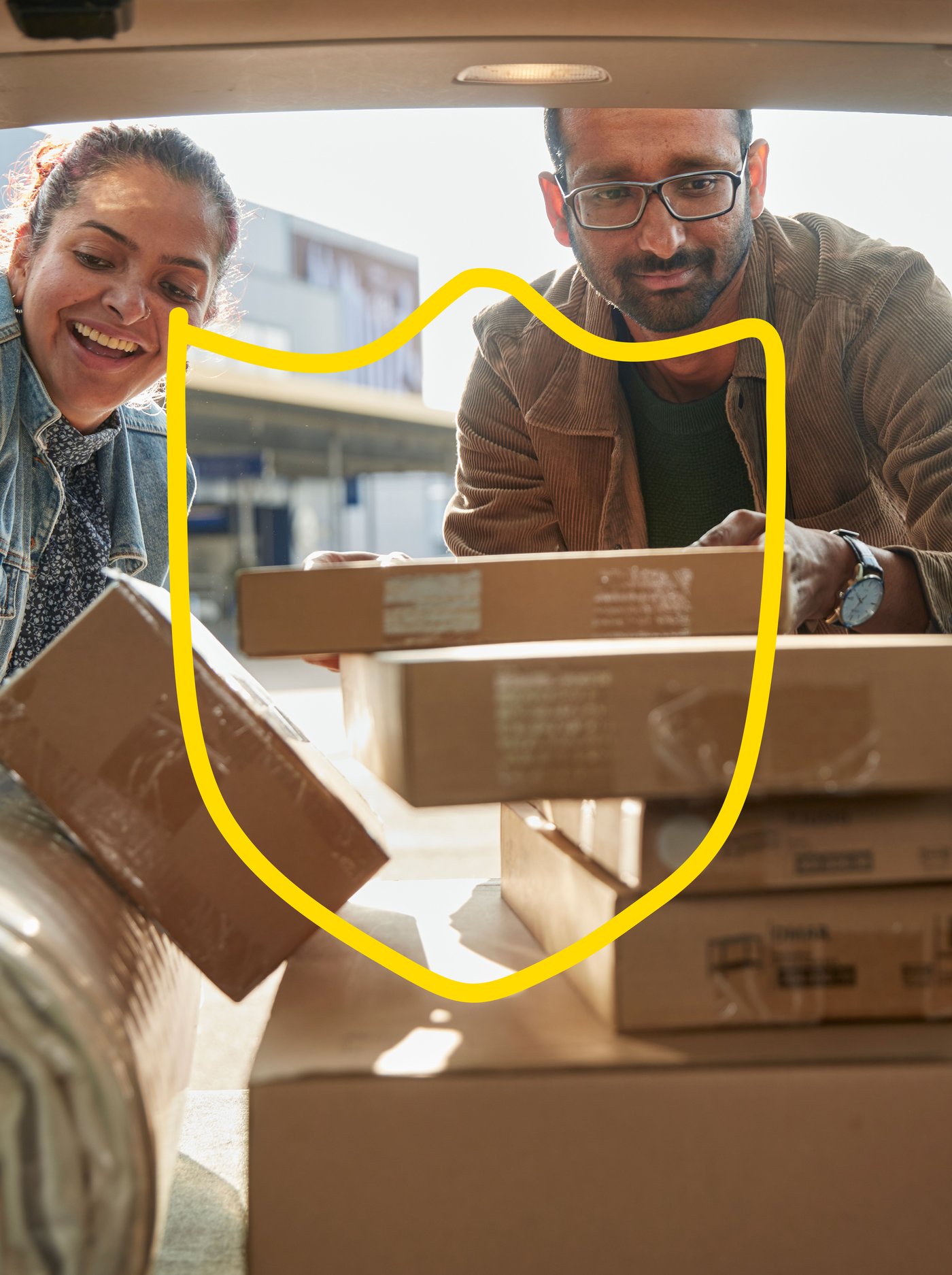 A man and a woman are loading IKEA purchases into a car.