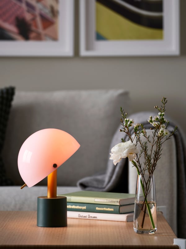 A light pink/dark grey-green NÖDMAST LED portable lamp, battery operated