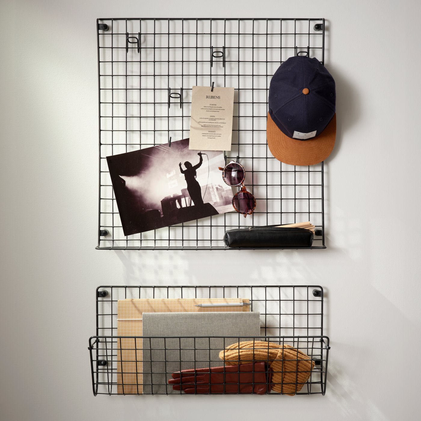 GREJIG wall pocket and wall grid with rail in black metal used for storing accessories and notes in a hallway.