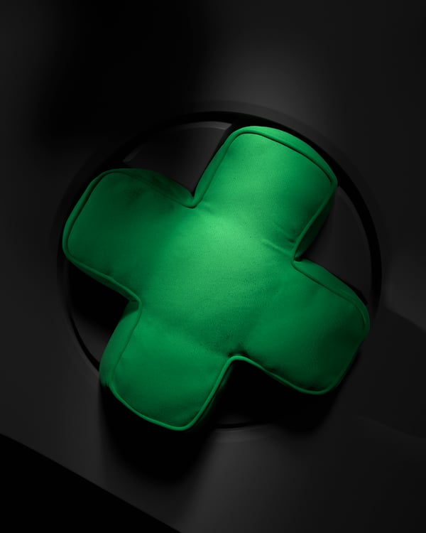 A green YXSTABY gaming D-pad cushion in the NA