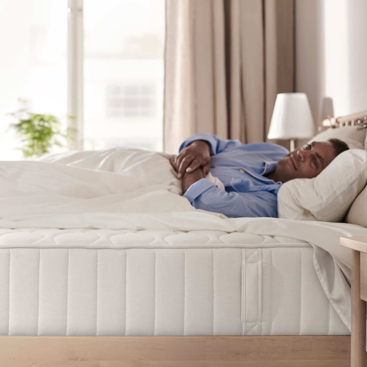 A firm/white VÅGSTRANDA pocket sprung mattress