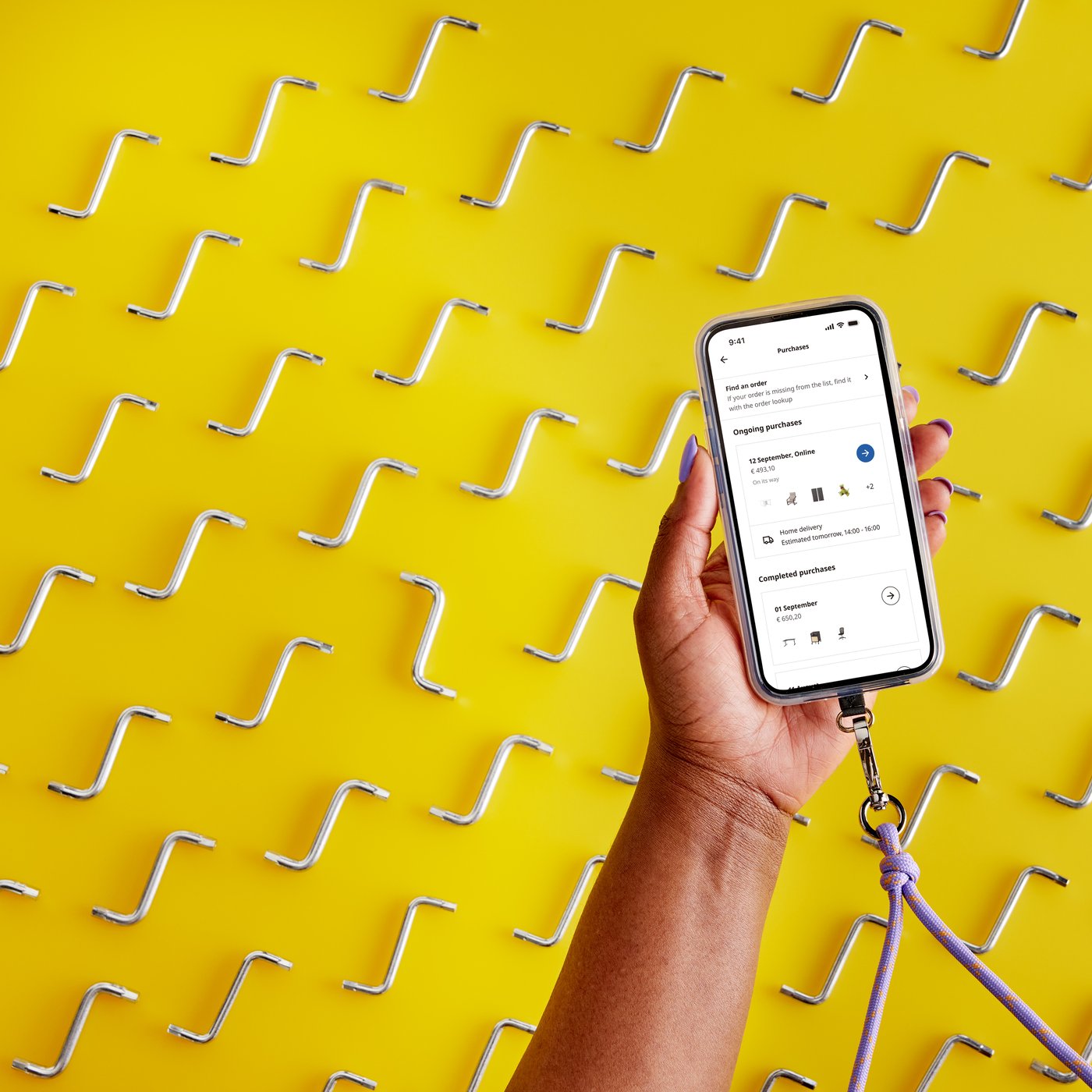 Hand holding mobile phone displaying IKEA mobile app 
