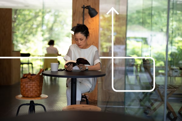 A lady reads a book in a cafe.