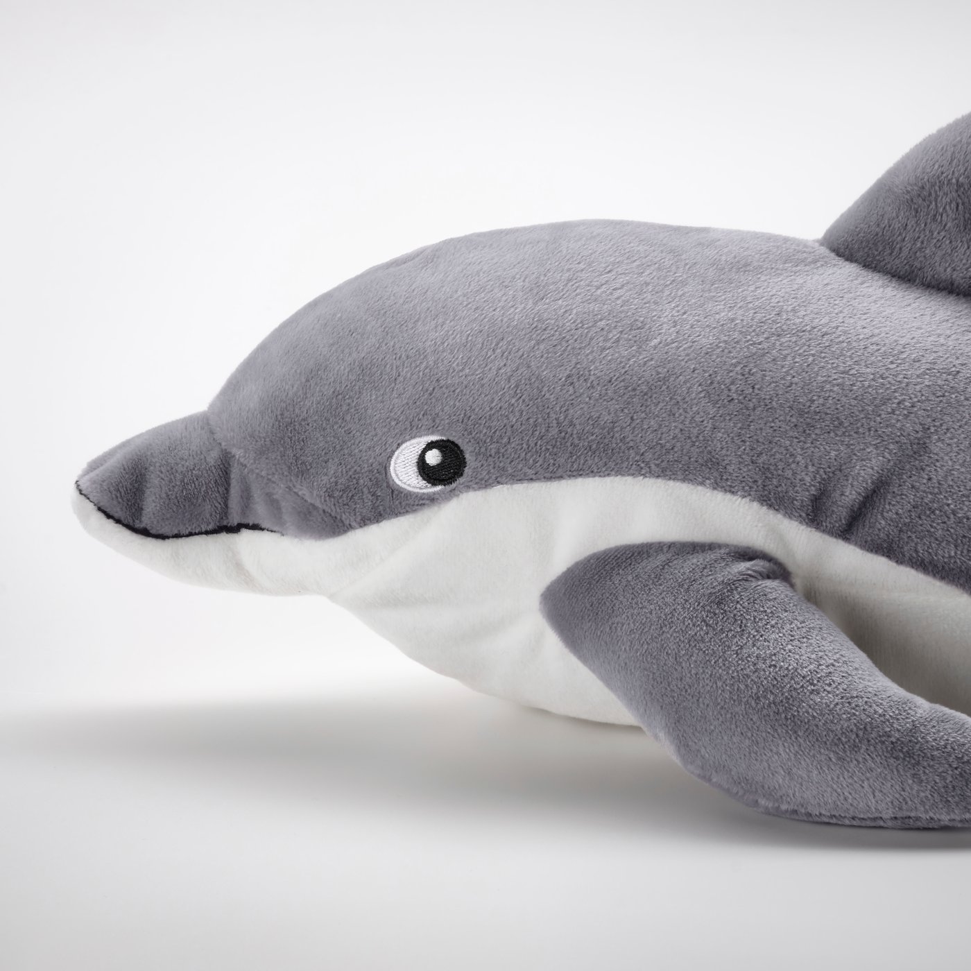 A dolphin/grey BLÅVINGAD soft toy in the NA