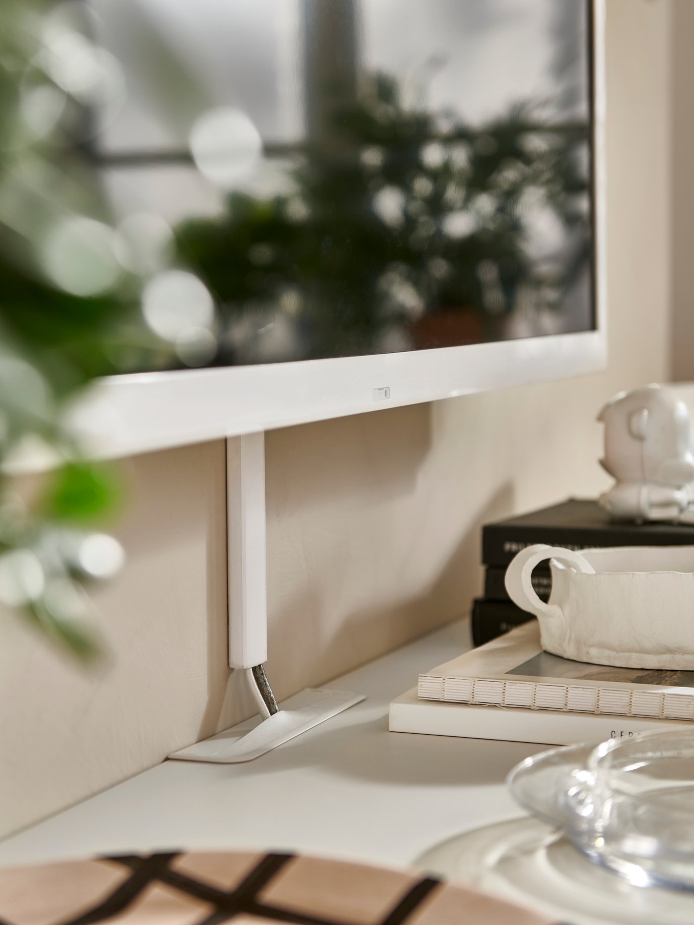 A white MONTERA cable trunking under a wall-mounted screen.