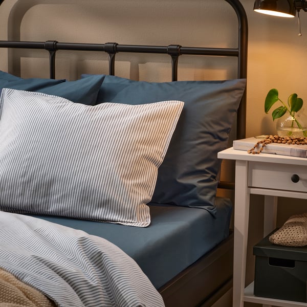 DVALA fitted sheet in blue over queen sized bed in bedroom