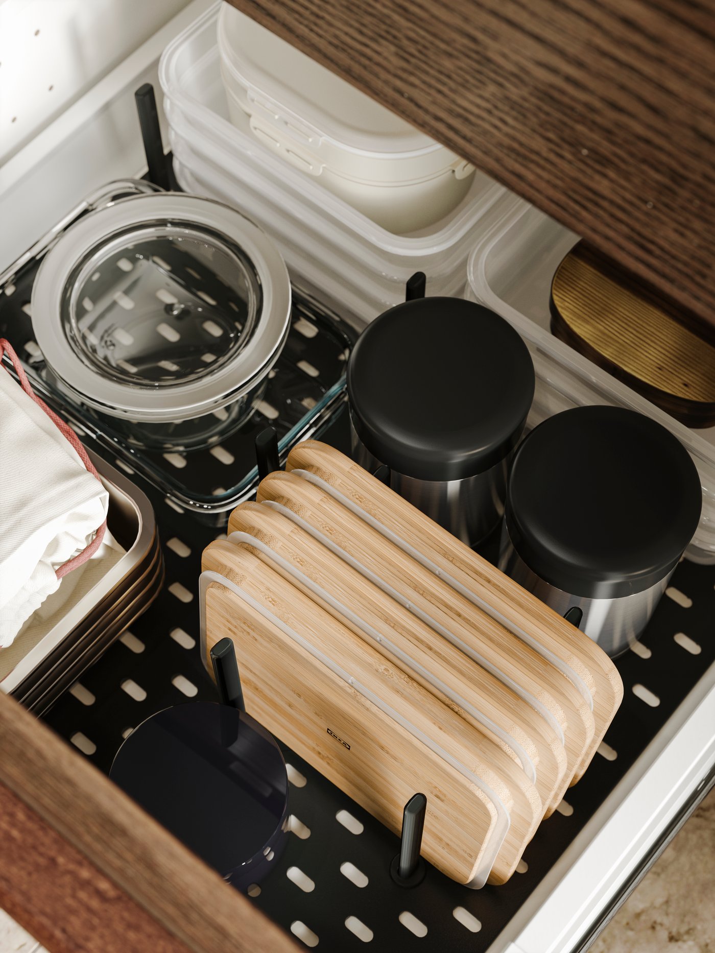 UPPDATERA pegboard drawers organiser storing bamboo lids, containers, and cloths, neatly arranged in a kitchen drawer.