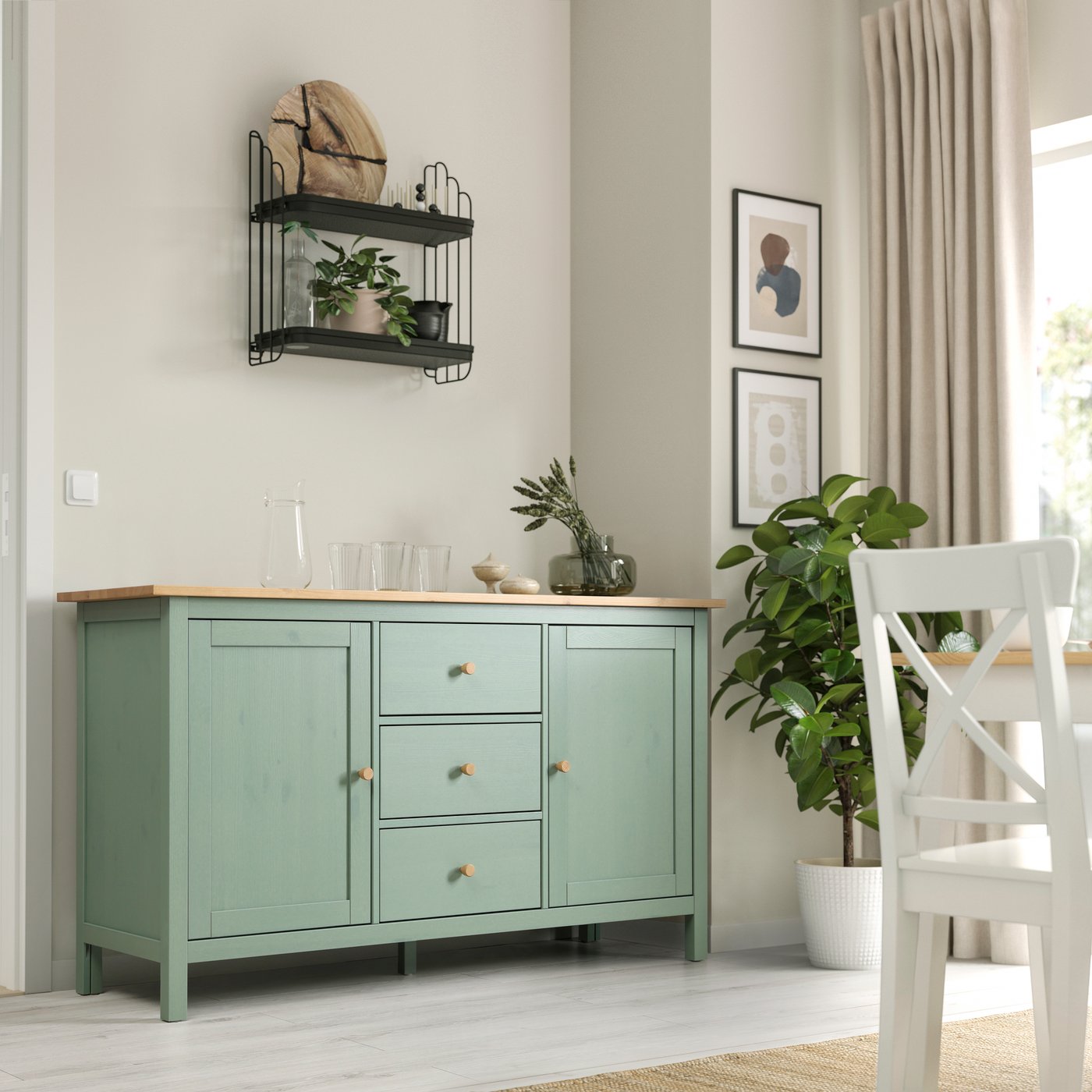 A grey-green/light brown stained HEMNES sideboard in the dining room