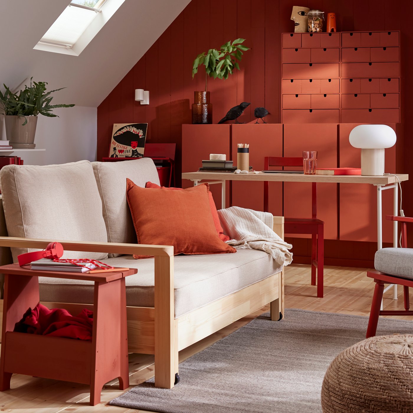 A TORNSBORG sleeper sofa stands in a family room with a grey TIDTABELL rug and red-painted pinewood storage.