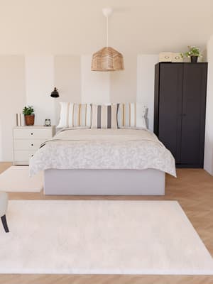 Chambre traditionnelle avec un lit, une commode et une armoire