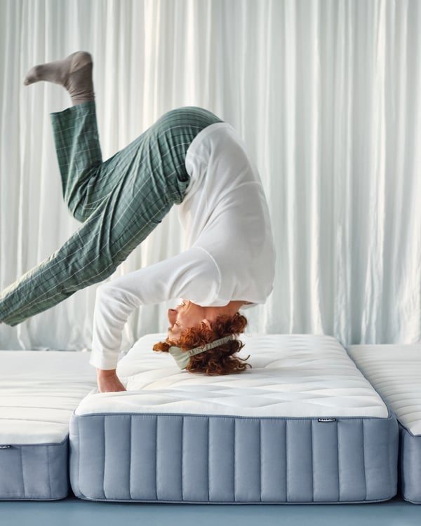 A firm/light blue VALEVÅG pocket sprung mattress
