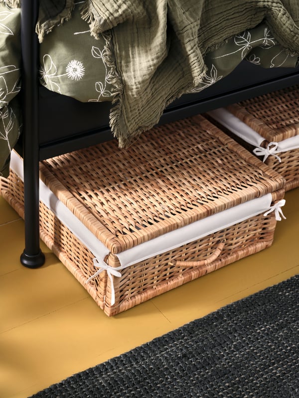 A grey-green VALLKRASSING throw in the bedroom