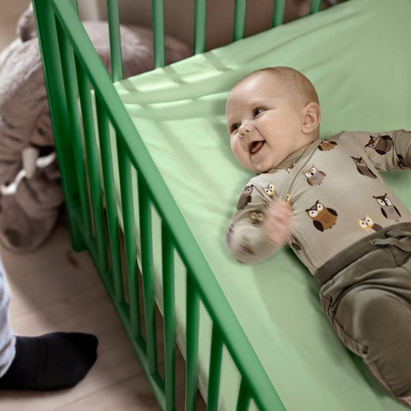 A green GULLIVER cot