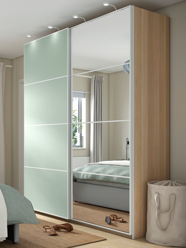 A white stained oak effect double sided/light green mirror glass PAX wardrobe with sliding doors