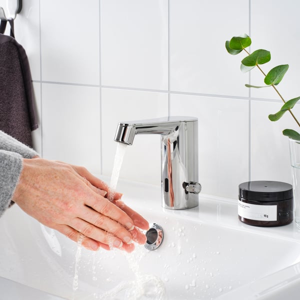 A chrome-plated BROGRUND wash-basin mixer tap with sensor in the bathroom