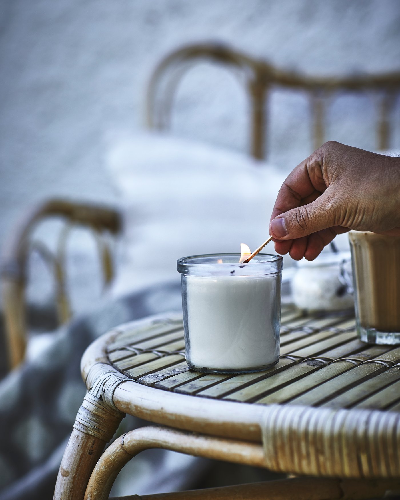 A Vanilla/light beige JÄMLIK scented candle in glass