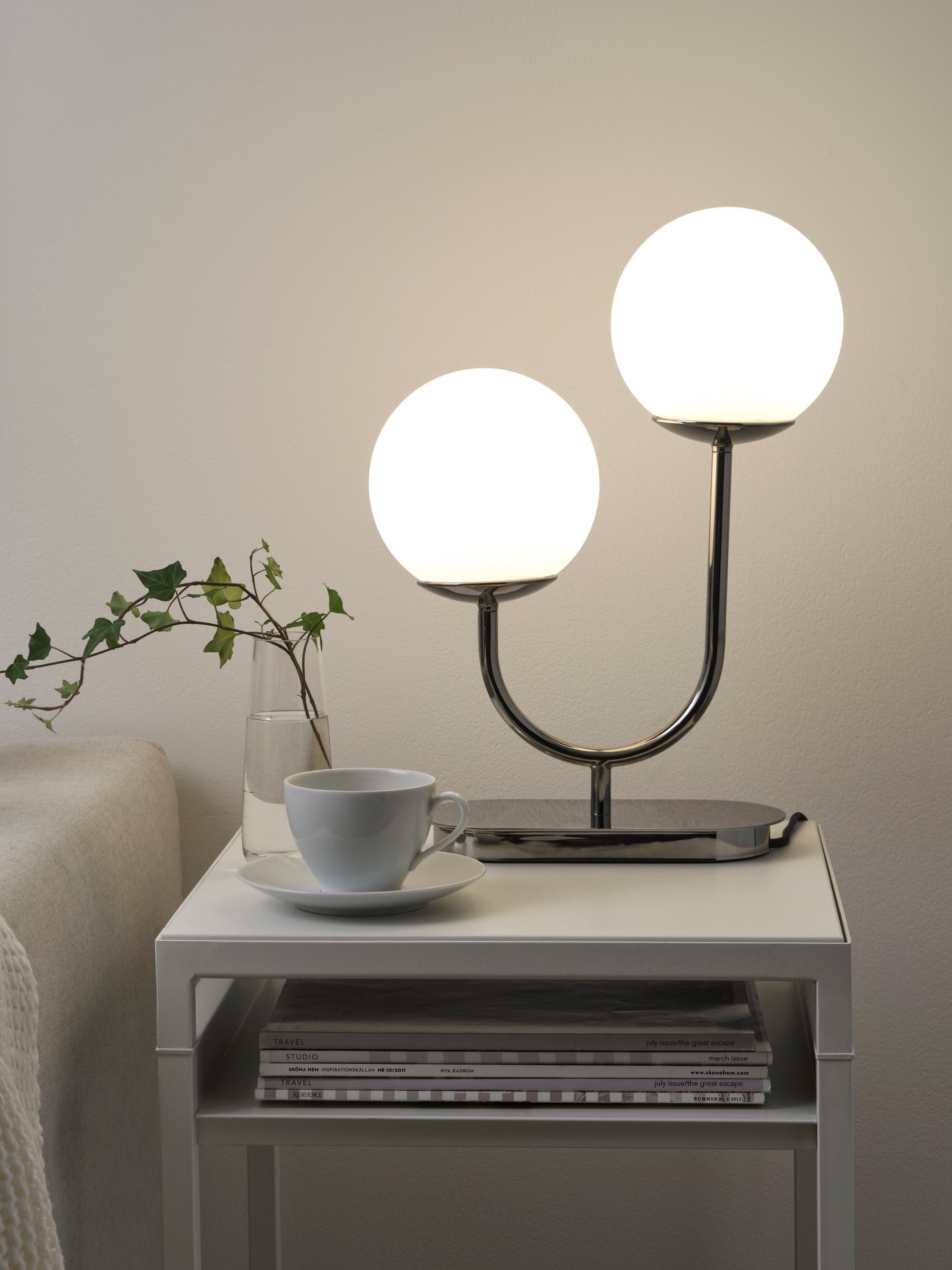 A chrome-plated/opal white glass SIMRISHAMN table lamp