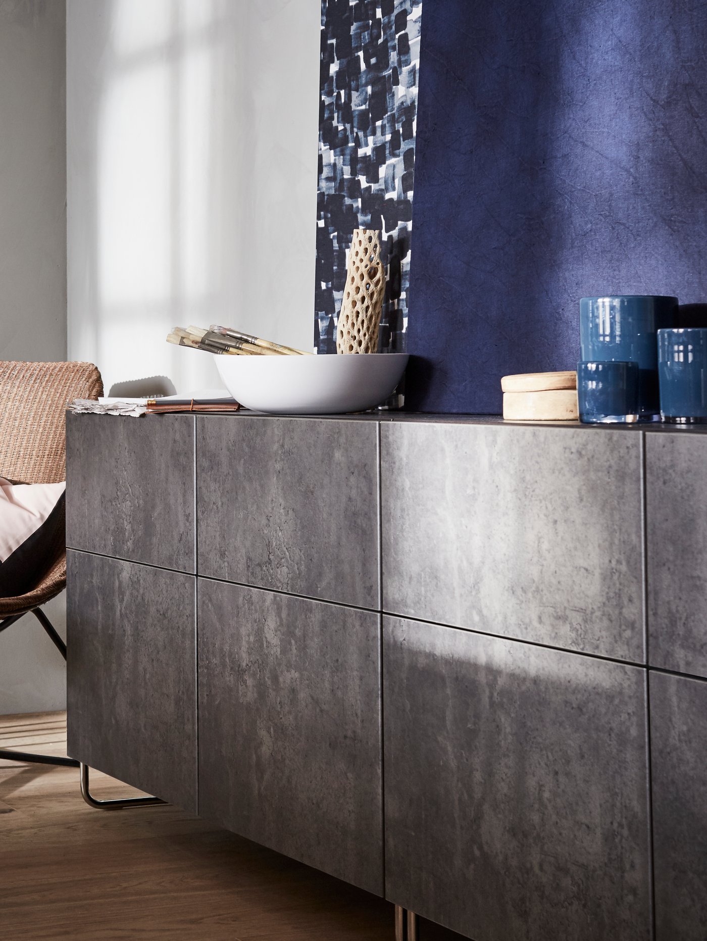 IKEA BESTÅ storage units with doors in a dark grey concrete faded effect with curved metal feet.