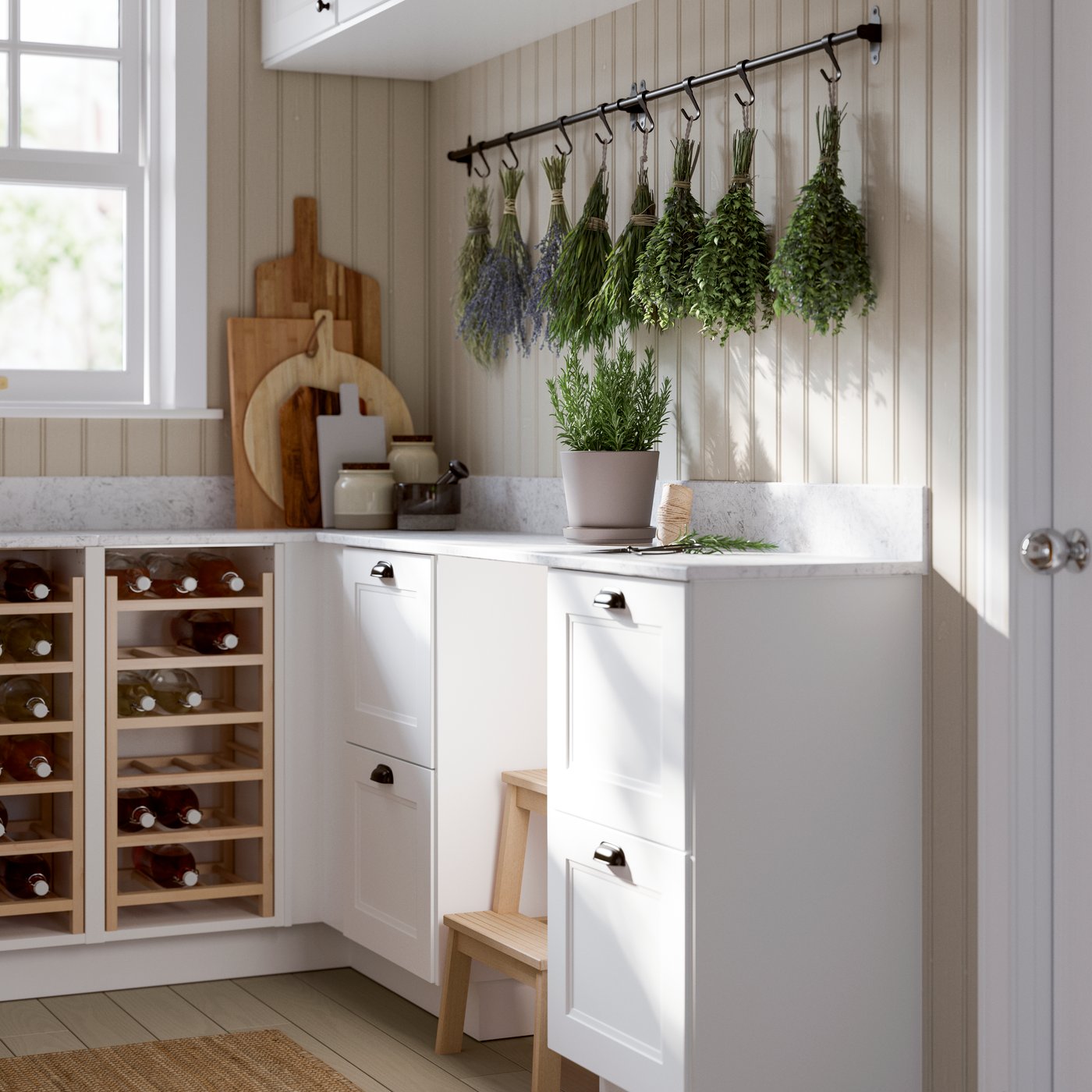 A bright pantry featuring a white wine rack, hanging herbs, and a potted plant on the countertop.
