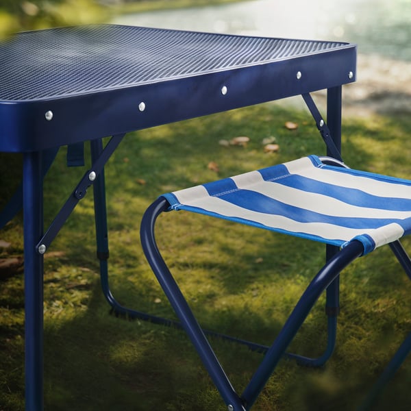 A blue STRANDÖN folding stool