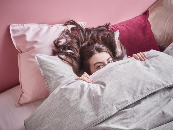 A light pink GURLI cushion cover